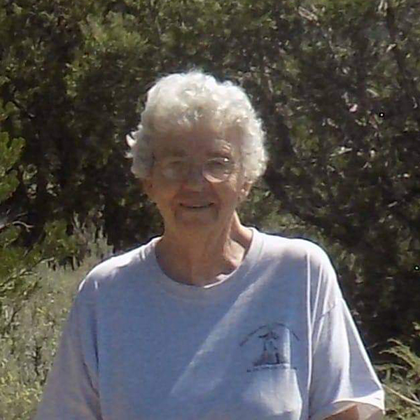 A close-up photo of Carol Hunter, DEEEP Coordinator, an older woman with short gray hair and glasses standing outside in warm weather